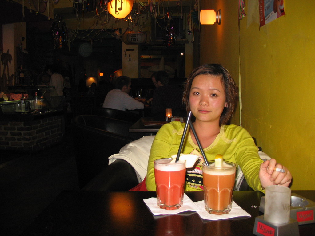 Miaomiao having cocktails at a bar in the city center
