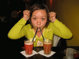 Miaomiao having cocktails at a bar in the city center