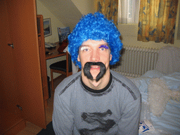 Tim with a wig, fake eyelashes and a fake mustache in our room at the Art Hotel Aachen