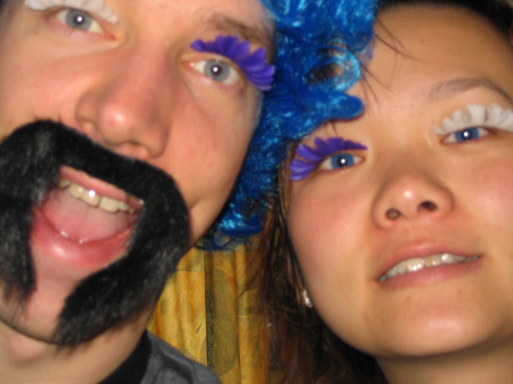 Tim and Miaomiao with a wig, fake eyelashes and a fake mustache in our room at the Art Hotel Aachen