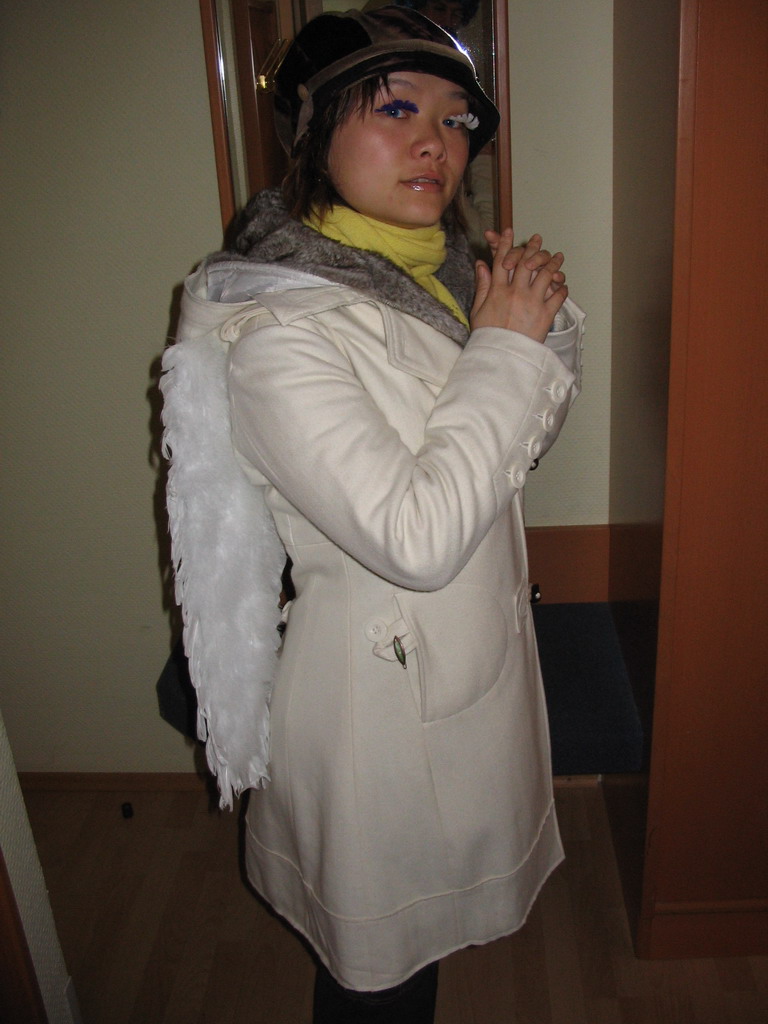 Miaomiao with fake eyelashes and angel wings in our room at the Art Hotel Aachen