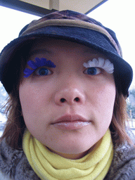 Miaomiao with fake eyelashes at the Buschhausen bus stop at the Kornelimünsterweg street