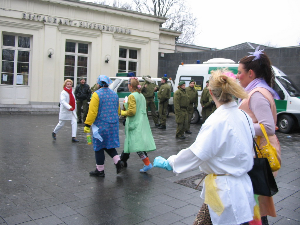Carnaval Parade and police officers in front of the Elisenbrunnen building at the Friedrich-Wilhelm-Platz square