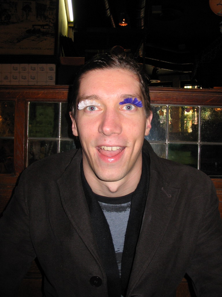 Tim with fake eyelashes at a restaurant in the city center