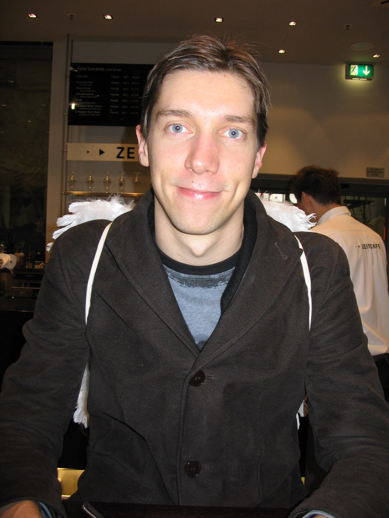 Tim with angel wings at a restaurant in the city center