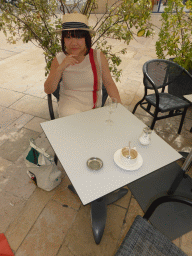 Miaomiao with a glass of wine at the Le Darius café at the Avenue Giuseppe Verdi