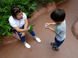 Miaomiao and Max with a Rainbow Lori at the Lori Landing building at the Vogelpark Avifauna zoo