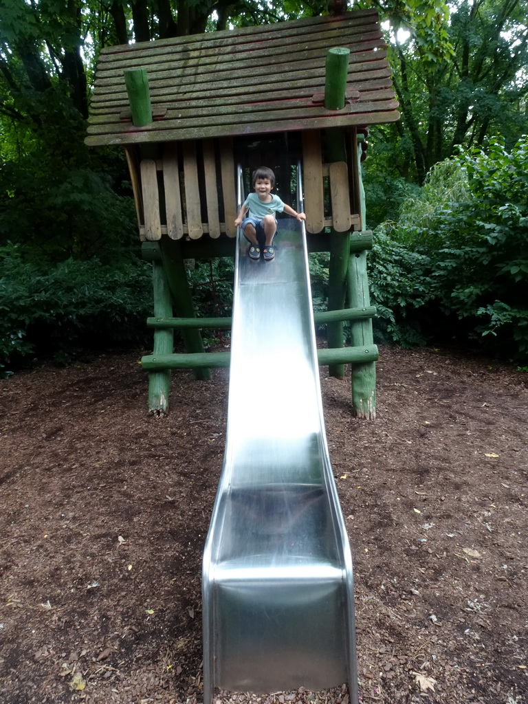 Max on a slide at the playground near the Lori Landing building at the Vogelpark Avifauna zoo