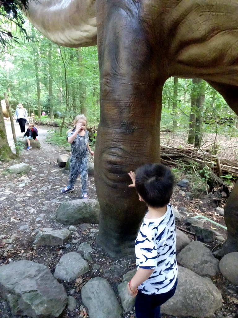 Max with a Diplodocus statue at the DinoPark at the DierenPark Amersfoort zoo