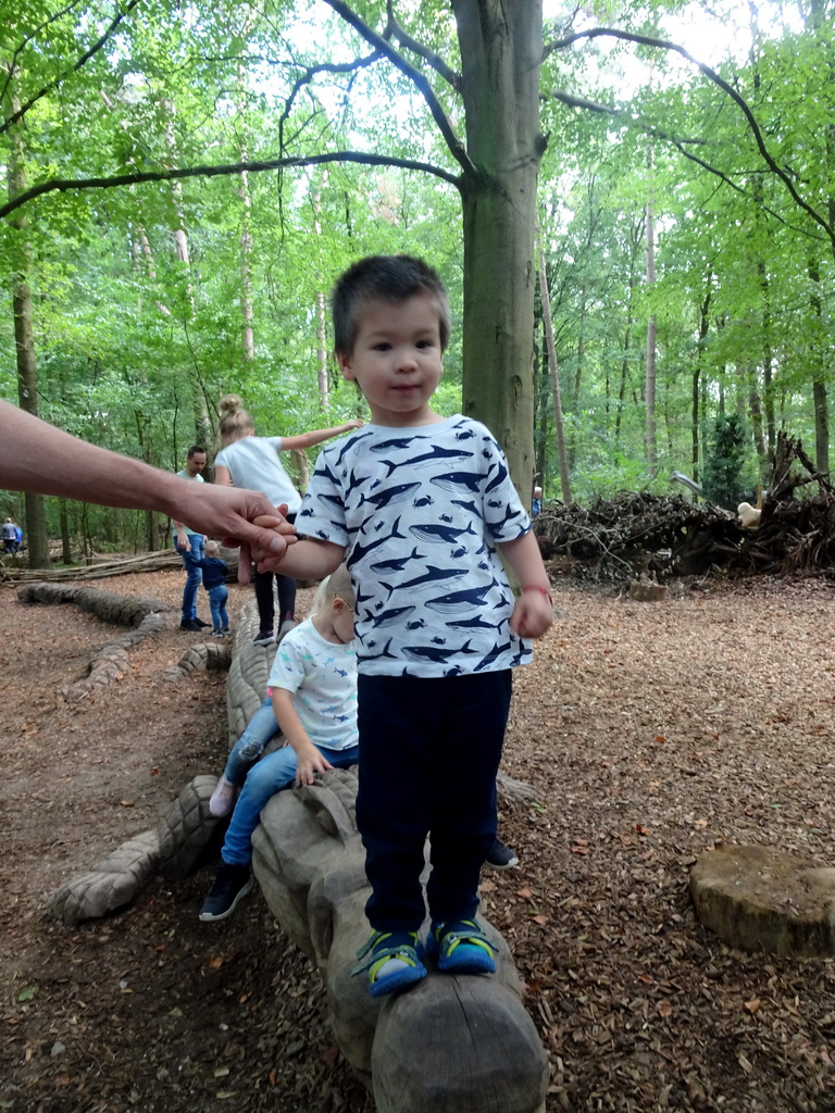 Max on a Crocodile statue at the DinoPark at the DierenPark Amersfoort zoo