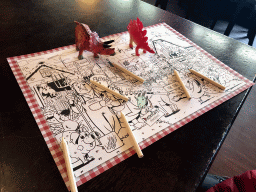 Dinosaur toys and coloring page with pencils at the Restaurant de Boerderij at the DierenPark Amersfoort zoo