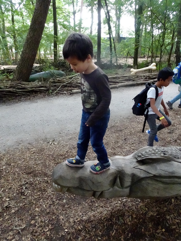 Max on a Crocodile statue at the DinoPark at the DierenPark Amersfoort zoo