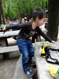 Max playing with dinosaur toys at the terrace of the Huid & Haar restaurant at the DinoPark at the DierenPark Amersfoort zoo