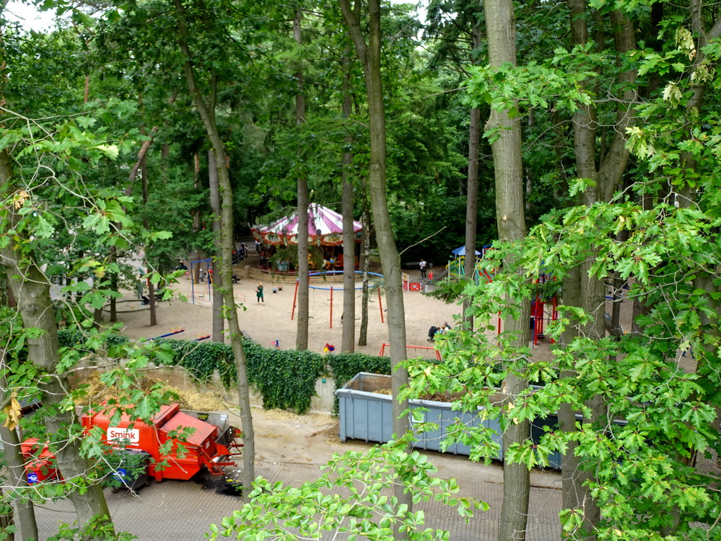 Carousel and playground at the Pretplein square at the DierenPark Amersfoort zoo, viewed from the parking garage