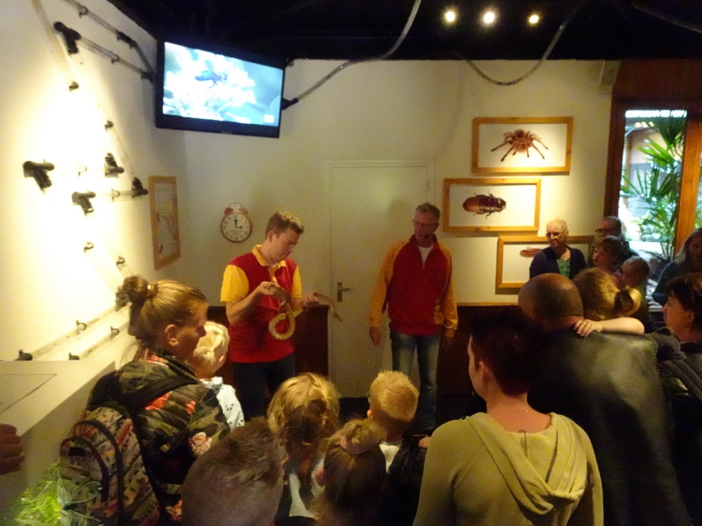 Zookeepers with a snake at the Honderdduizend Dierenhuis building at the DierenPark Amersfoort zoo