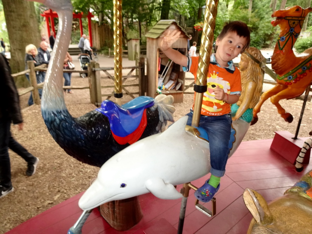 Max on a Dolphin statue at the Carousel at the Pretplein square at the DierenPark Amersfoort zoo