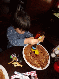 Max eating a pancake at the Restaurant de Boerderij at the DierenPark Amersfoort zoo