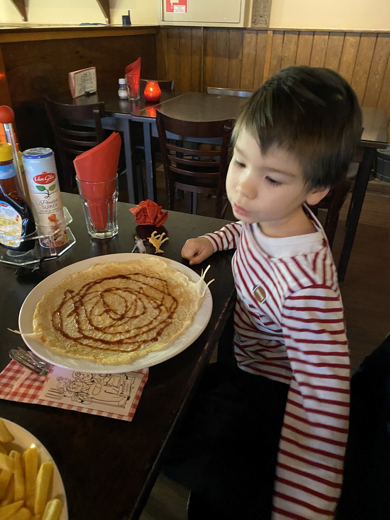 Max eating a pancake at the Restaurant de Boerderij at the DierenPark Amersfoort zoo