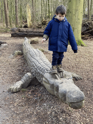 Max on a Crocodile statue at the DinoPark at the DierenPark Amersfoort zoo