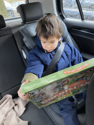 Max with a Safari-Opoly game in the car to home