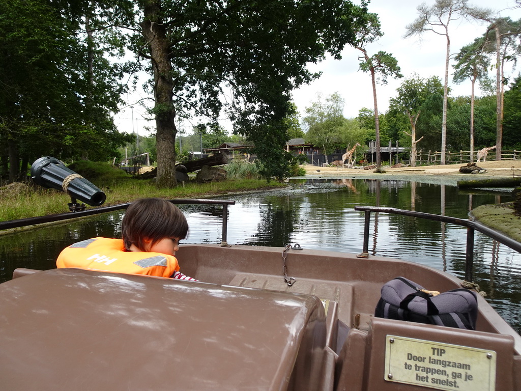 Max on the cycle boat on the Expedition River at the DierenPark Amersfoort zoo, with a view on the Giraffes and East African Oryxes