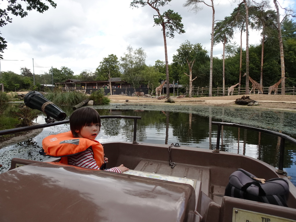 Max on the cycle boat on the Expedition River at the DierenPark Amersfoort zoo, with a view on the Giraffes and East African Oryxes
