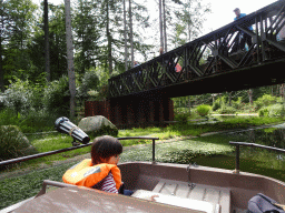 Max on the cycle boat on the Expedition River at the DierenPark Amersfoort zoo, with a view on the Bailey Bridge