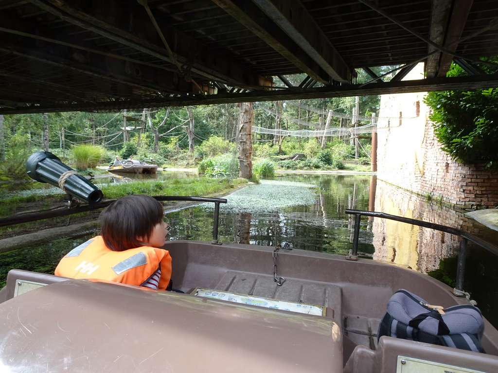 Max on the cycle boat on the Expedition River at the DierenPark Amersfoort zoo, with a view on the Bailey Bridge and the island with Golden-bellied Capuchins