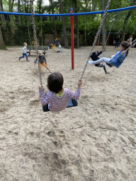 Max on a swing at the playground at the Pretplein square at the DierenPark Amersfoort zoo