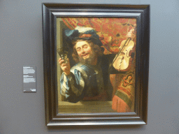 Painting `The Merry Fiddler` by Gerard van Honthorst, with explanation, at Room 2.1 at the Second Floor of the Rijksmuseum