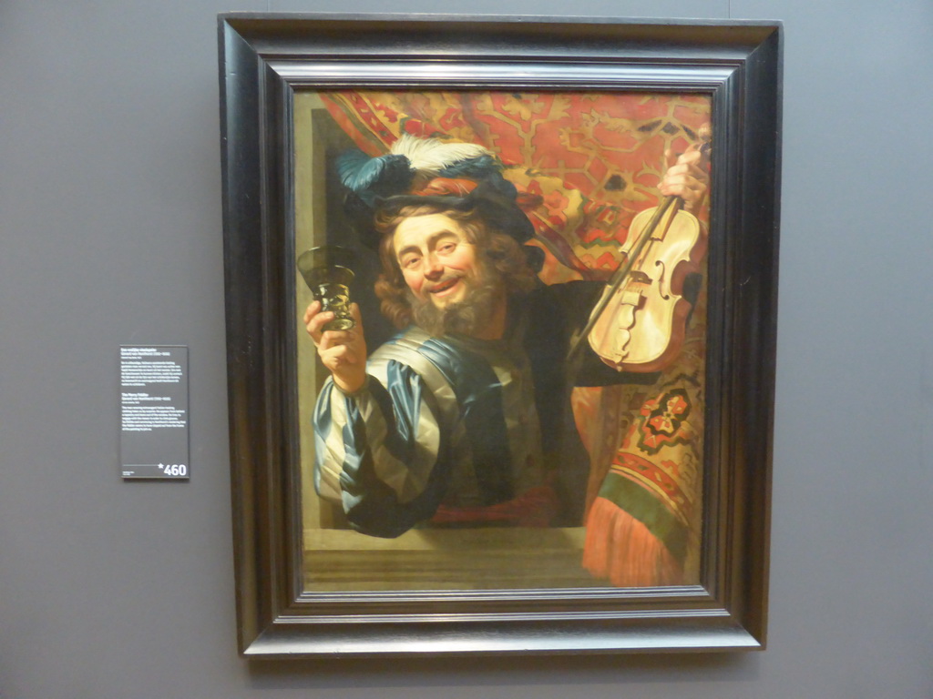 Painting `The Merry Fiddler` by Gerard van Honthorst, with explanation, at Room 2.1 at the Second Floor of the Rijksmuseum