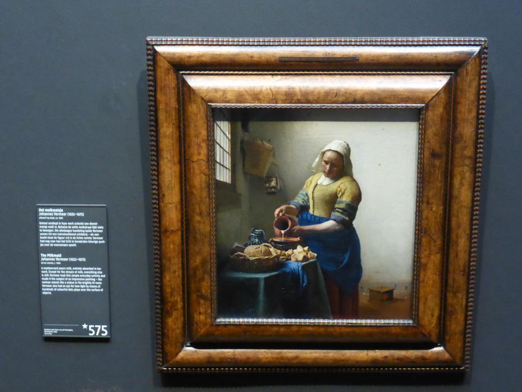 Painting `The Milkmaid` by Johannes Vermeer, with explanation, at the Gallery of Honour at the Second Floor of the Rijksmuseum