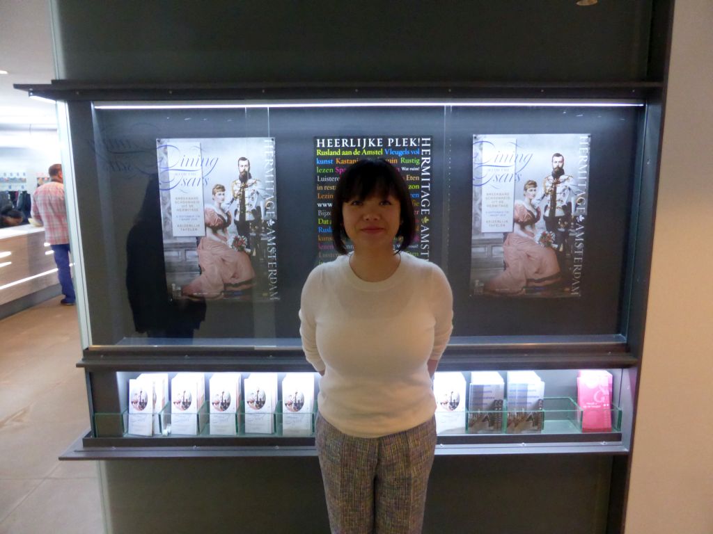 Miaomiao in front of posters on the exhibition `Dining with the Tsars` at the Ground Floor of the Hermitage Amsterdam museum