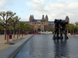 Pool with statue, the `I Amsterdam` sign and the back side of the Rijksmuseum at the Museumplein square