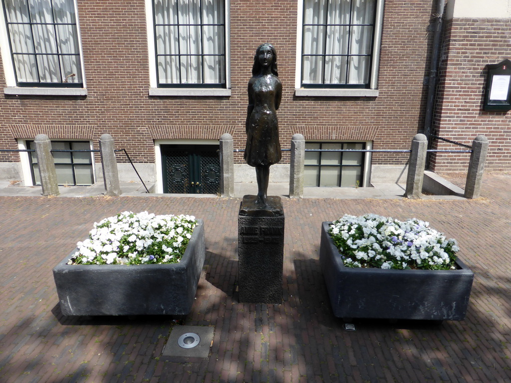Statue of Anne Frank in front of the Westerkerk church at the Westermarkt square