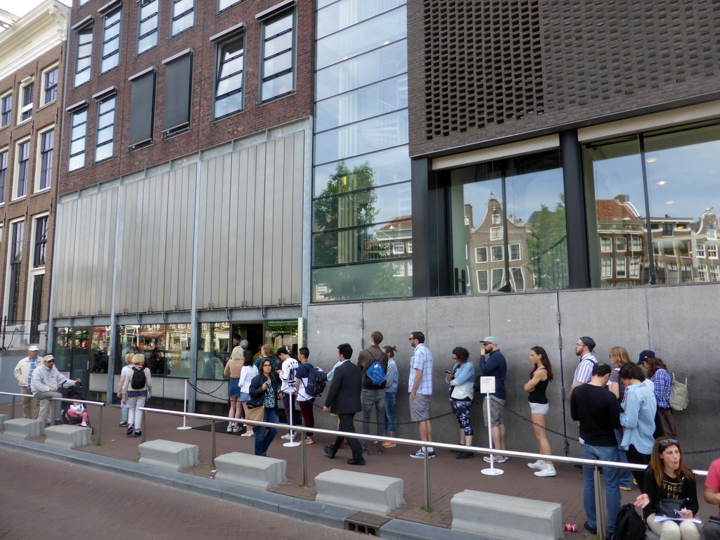 People waiting in line in front of the Anne Frank House museum at the Prinsengracht canal