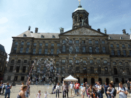 People blowing bubbles in front of the Royal Palace Amsterdam at the Dam square