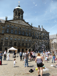 People blowing bubbles in front of the Royal Palace Amsterdam and the Nieuwe Kerk church at the Dam square