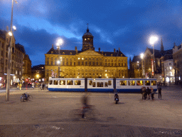Tram, the Royal Palace Amsterdam and the Nieuwe Kerk church at the Dam Square, by night