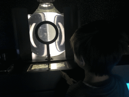 Max looking at a White Mosquito larvae at the Upper Floor of the Micropia museum