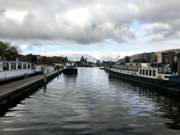 Boats in the Oosterdok canal, the Basilica of St. Nicholas and the Amsterdam Central Railway Station, viewed from the Oosterdok street