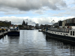 Boats in the Oosterdok canal, the Basilica of St. Nicholas and the Amsterdam Central Railway Station, viewed from the Oosterdok street