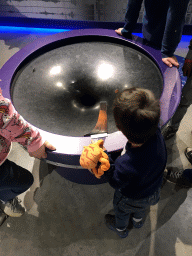 Max with a spiral wishing well at the Fenomena exhibition at the First Floor of the NEMO Science Museum