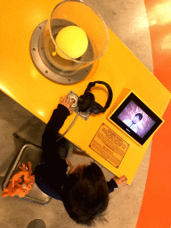 Max with a balloon vacuum game at the Fenomena exhibition at the First Floor of the NEMO Science Museum