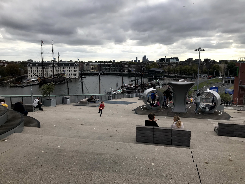 The Energetica exhibition at the roof at the Fifth Floor of the NEMO Science Museum, with a view on the Oosterdok canal and the National Maritime Museum with the replica of the `Amsterdam` ship