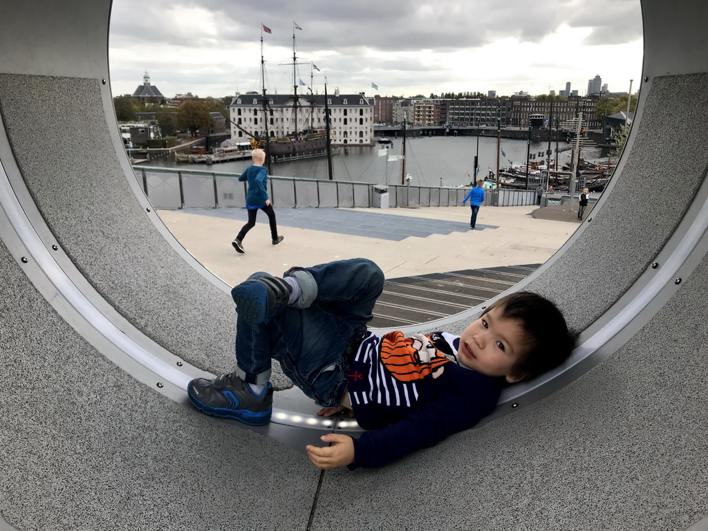 Max at the Solar Island at the Energetica exhibition at the roof at the Fifth Floor of the NEMO Science Museum, with a view on the Oosterdok canal and the National Maritime Museum with the replica of the `Amsterdam` ship