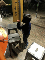 Max with headphones on at the Humania exhibition at the Fourth Floor of the NEMO Science Museum