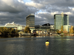 Boat in the Oosterdok canal, the Muziekgebouw aan `t IJ building, the Mövenpick Hotel Amsterdam City Centre, the UP Office Building and a cruise ship, viewed from the Mr. J.J. van der Veldebrug bridge