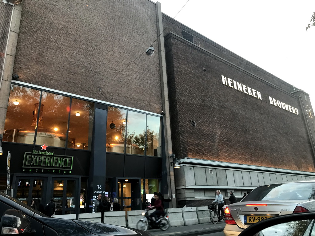 Front of the Heineken Experience brewery at the Stadhouderskade street, viewed from the car, at sunset