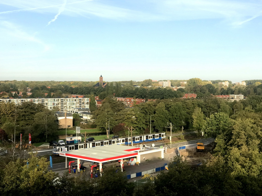 Tram at the Beneluxbaan street of Amstelveen and the tower of the St. Augustinuskerk church, viewed from the roof of the Cityden Up hotel